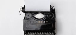 Antique typewriter with a blank page inserted.